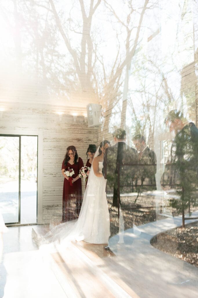 Bride and groom at altar exchanging vows in the little white chapel at Soli Deo Gloria weddings and events in Decatur