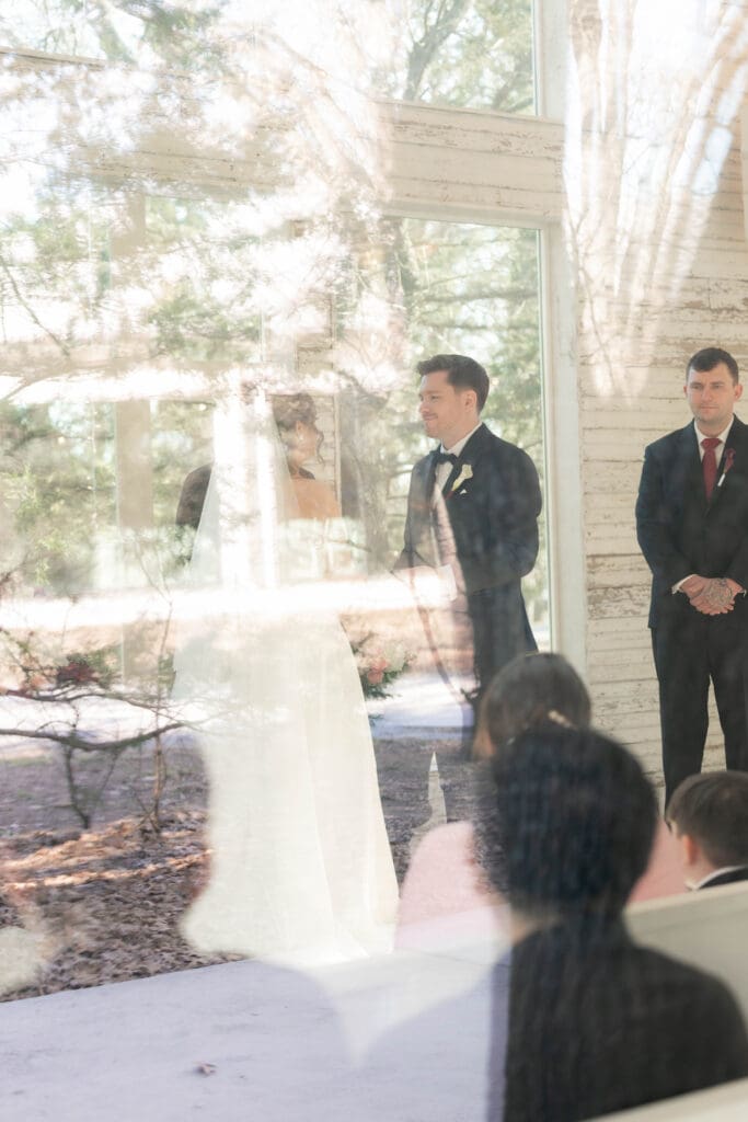 Bride and groom at altar exchanging vows in the little white chapel at Soli Deo Gloria weddings and events in Decatur