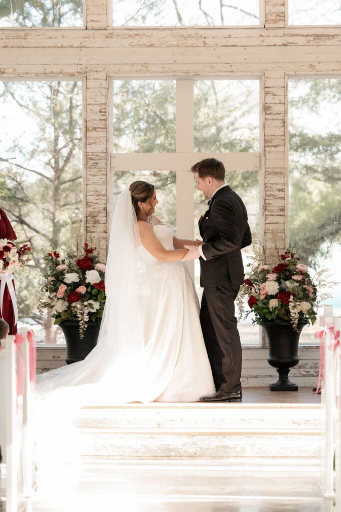 Bride and groom at altar kissing in the little white chapel at Soli Deo Gloria weddings and events in Decatur