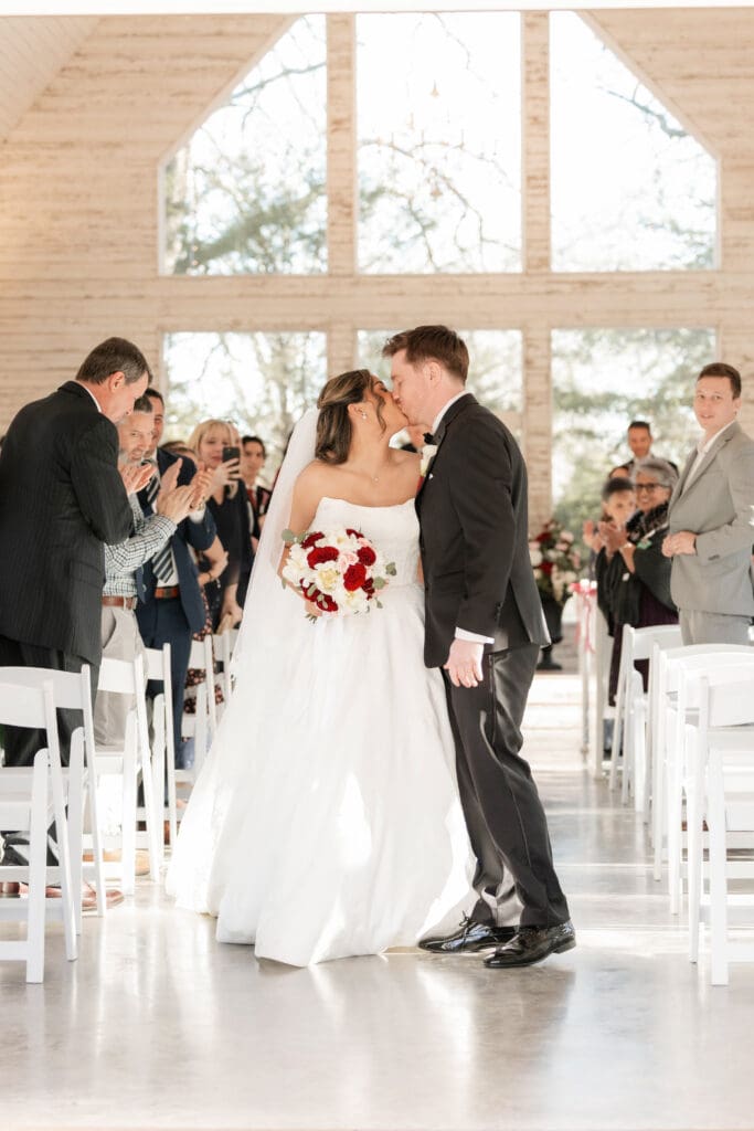 Bride and groom kissing inside the chapel