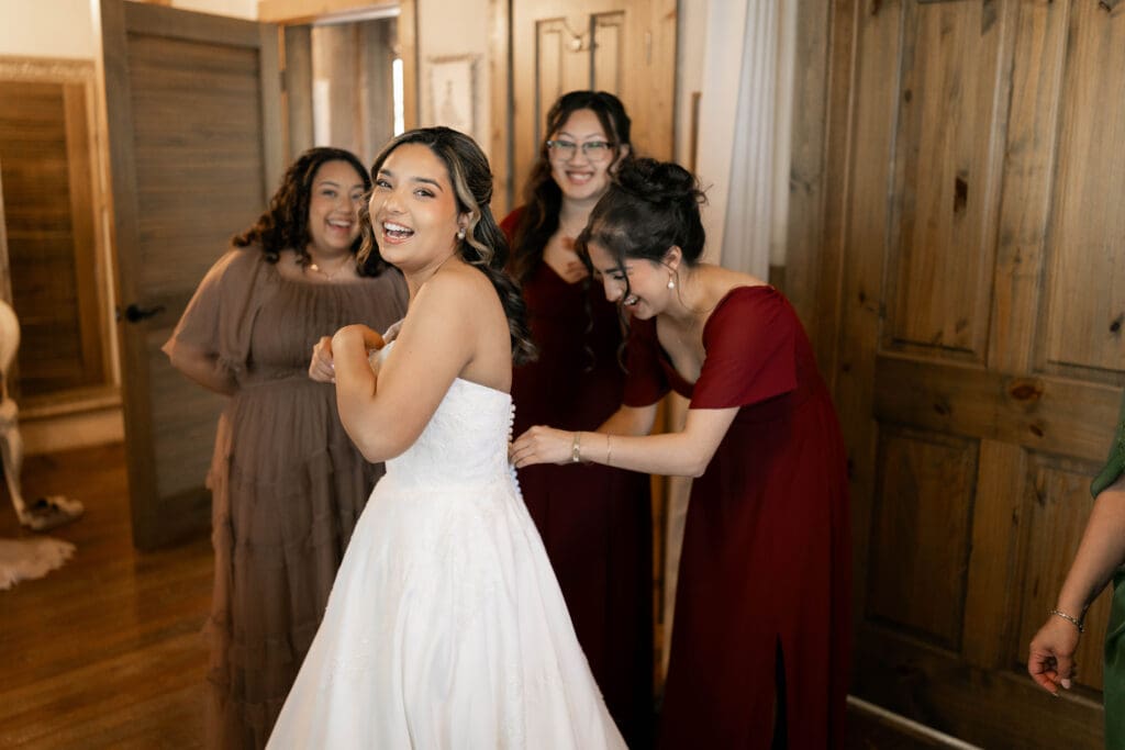 Bridesmaids helping the bride get ready