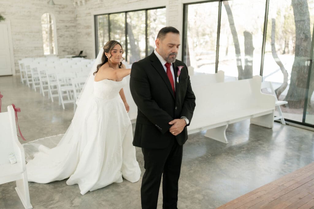 Bride doing a first look with her father in the chapel