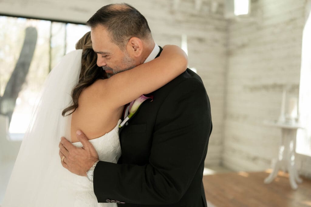 Bride doing a first look with her father in the chapel