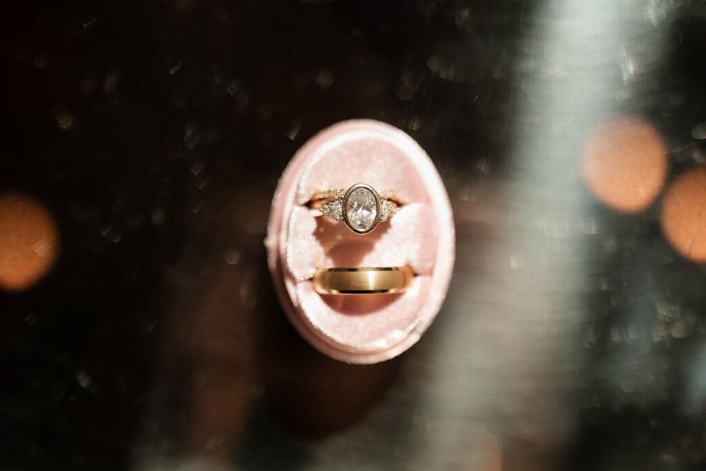 Close up of bride and groom's wedding rings in cute velvet ring box
