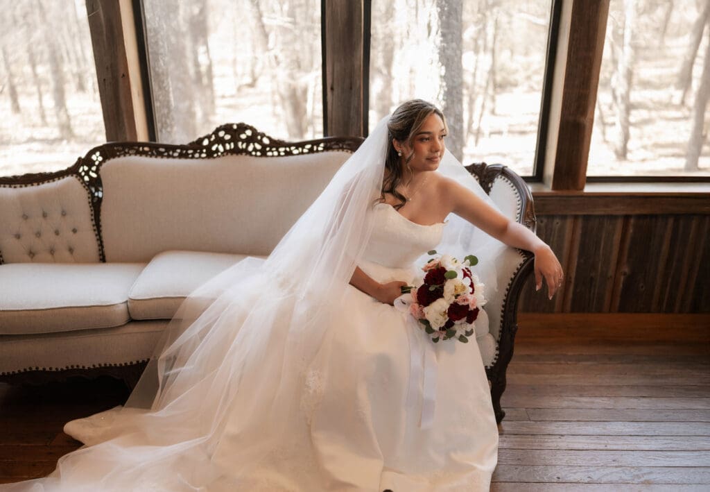 Bride sitting on vintage bench in the bridal suite