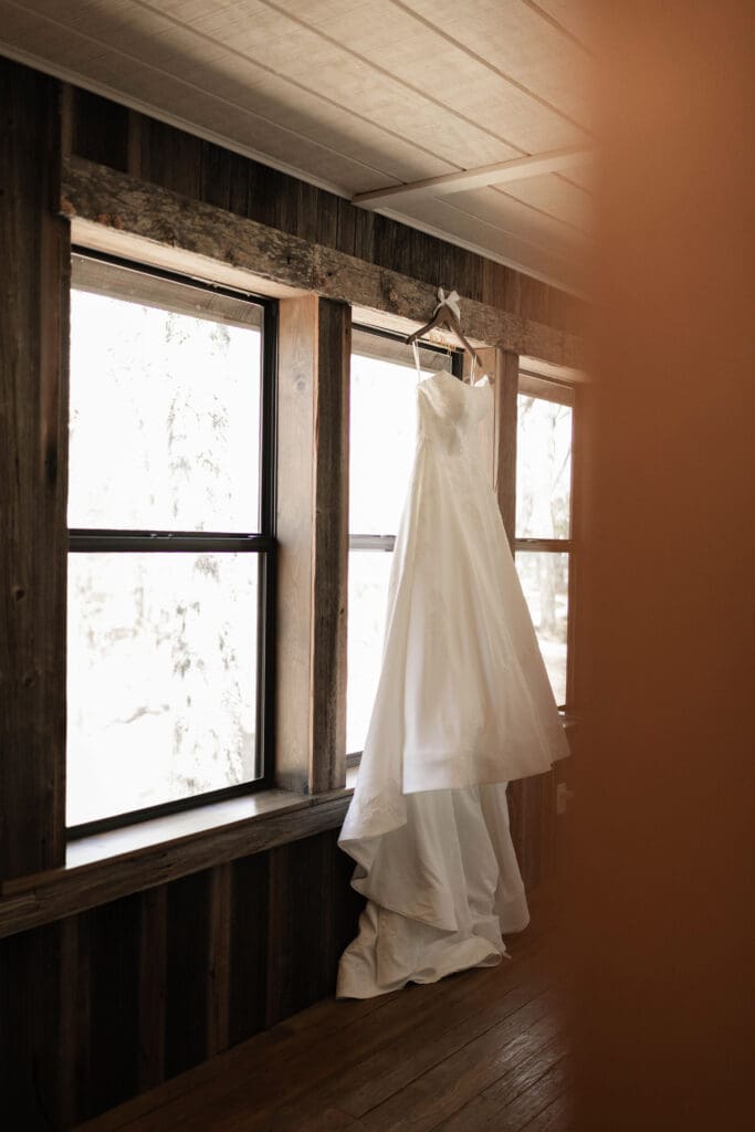 Wedding dress hanging from window