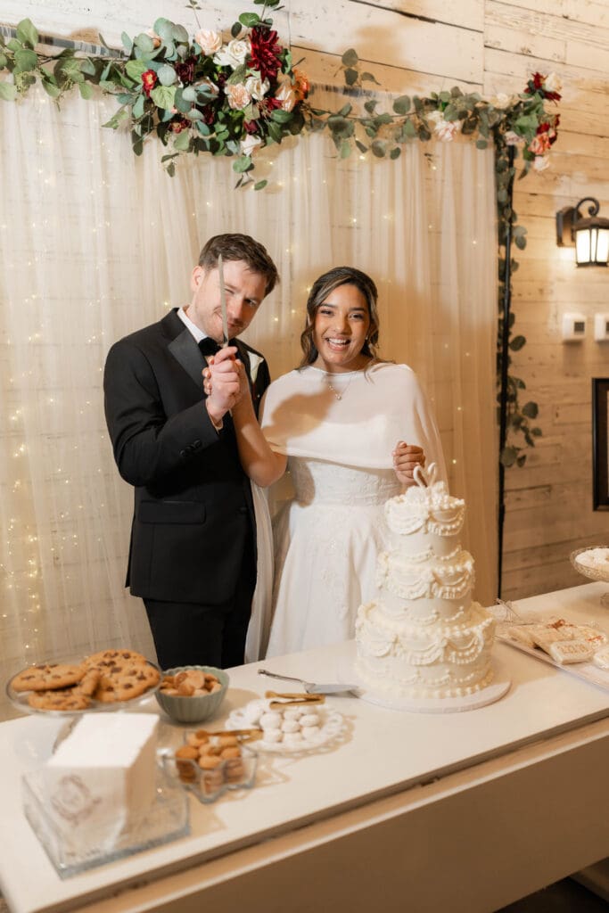 Bride and groom cutting their wedding cake