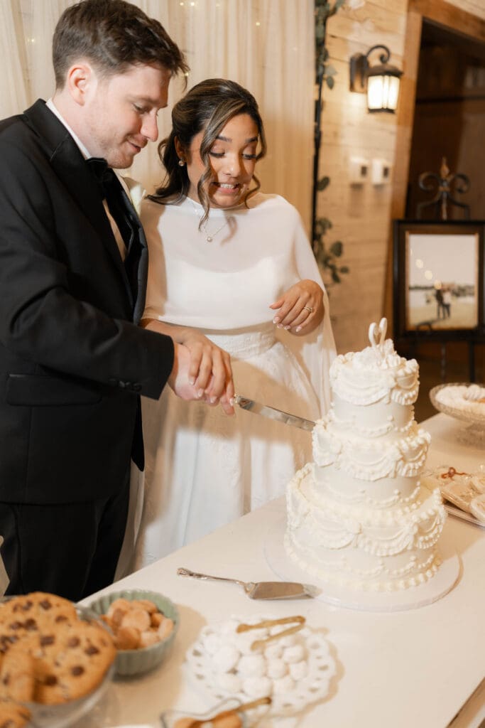 Bride and groom cutting their wedding cake