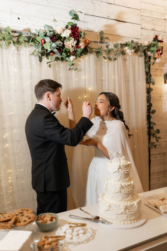 Bride and groom cutting their wedding cake