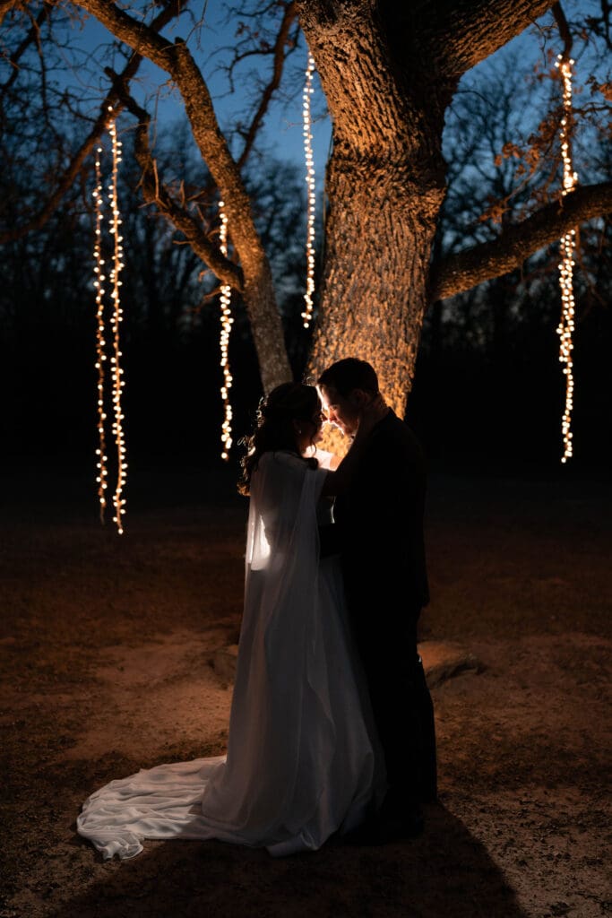 Moody silhouette portraits of the bride and groom outside under the large tree at Soli Deo Gloria in Decatur