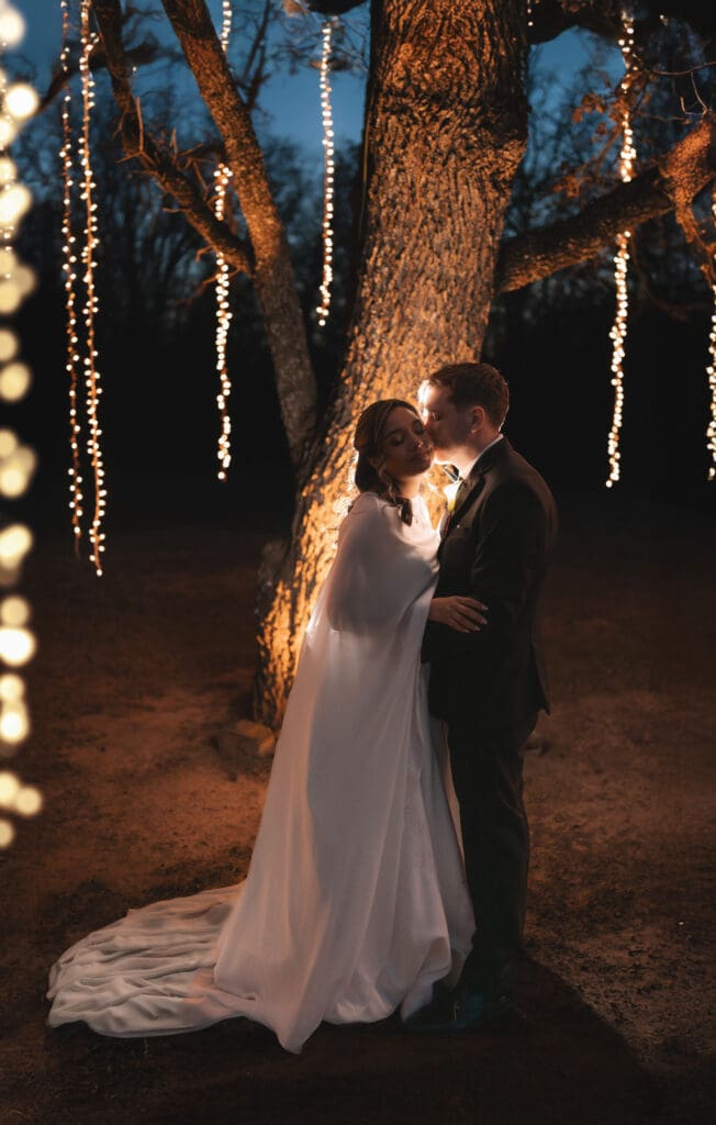 Moody silhouette portraits of the bride and groom outside under the large tree at Soli Deo Gloria in Decatur