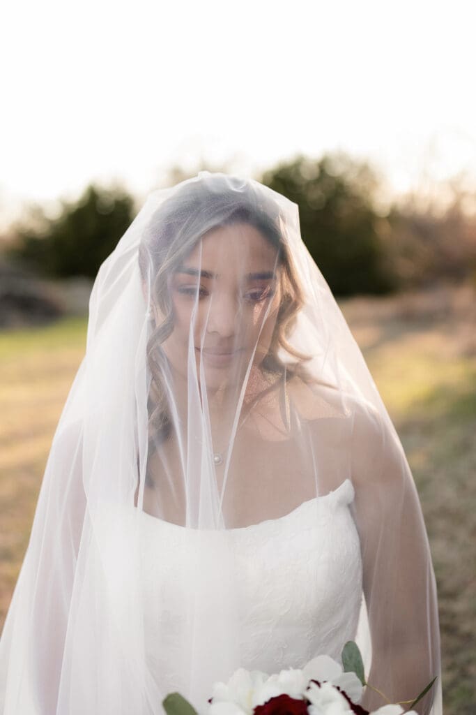Bride taking golden hour portraits outside at Soli Deo Gloria in Decatur