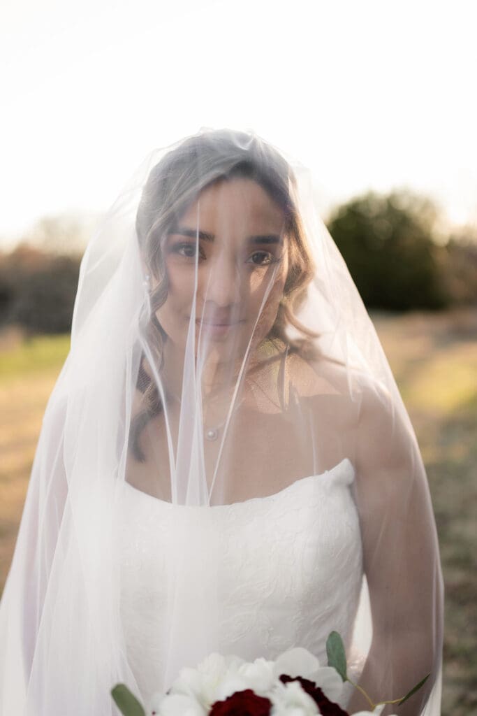 Bride taking golden hour portraits outside at Soli Deo Gloria in Decatur
