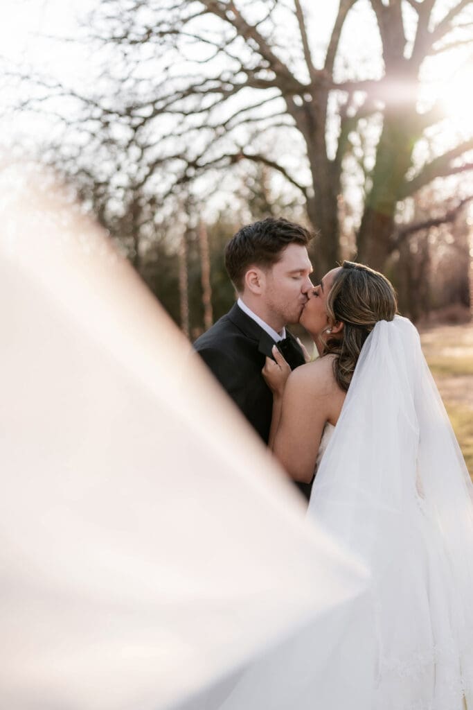 Wedding photography of bride and groom outside with the sun setting behind them in Decatur, TX
