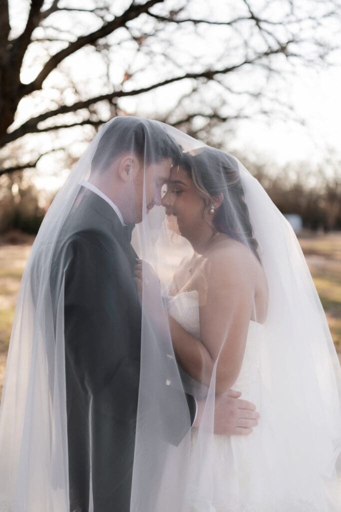 Wedding photography of bride and groom outside with the sun setting behind them in Decatur, TX