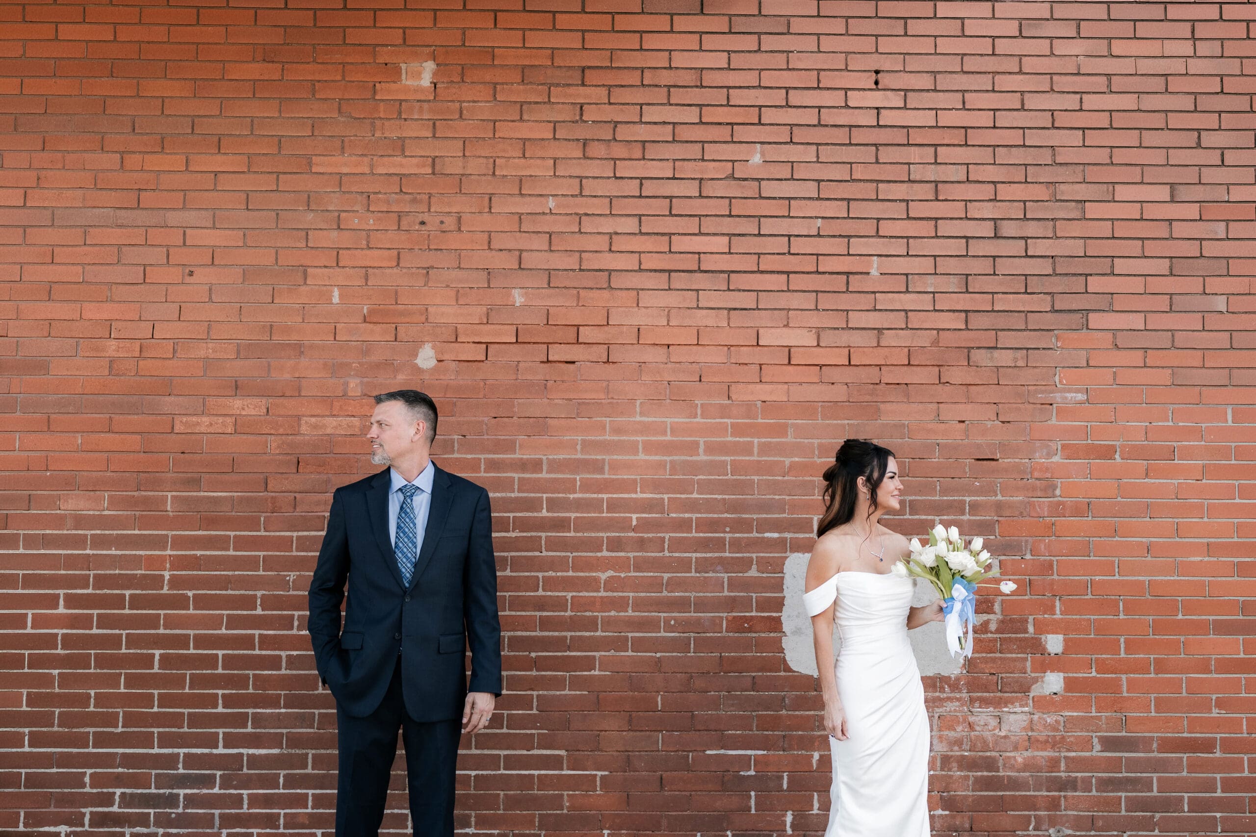 Bride and groom posing outside of Soma Winery in Fort Worth, TX