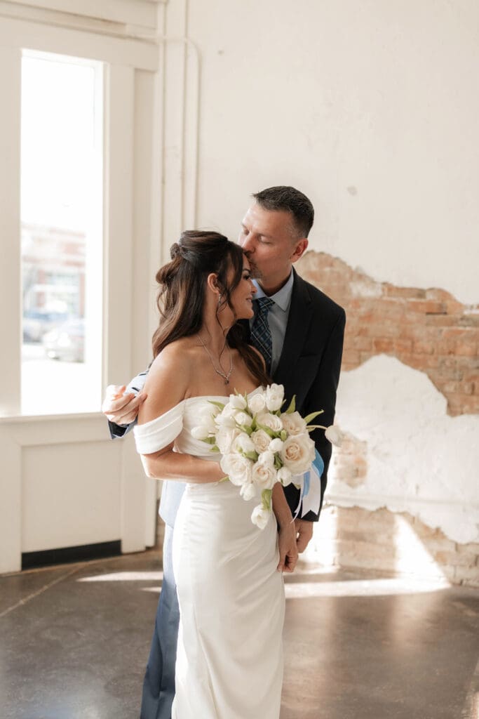 Bride and groom posing for photos inside Soma Winery in Fort Worth, TX