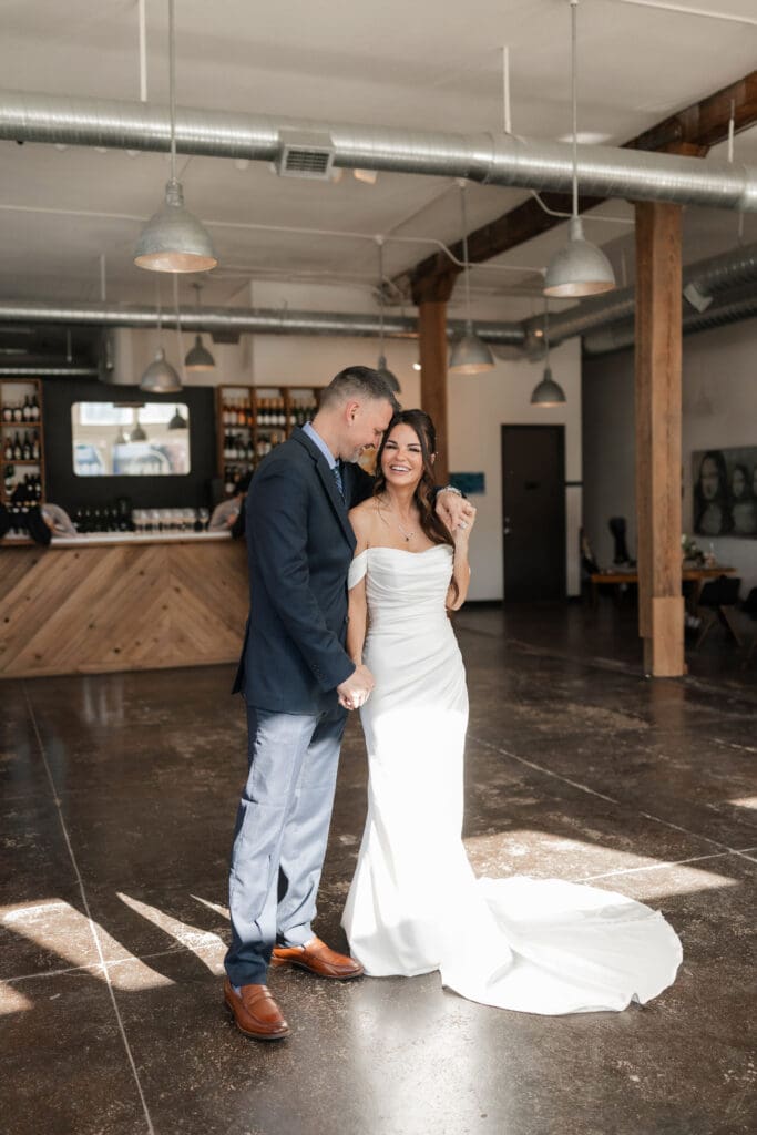 Bride and groom posing for photos inside Soma Winery in Fort Worth, TX
