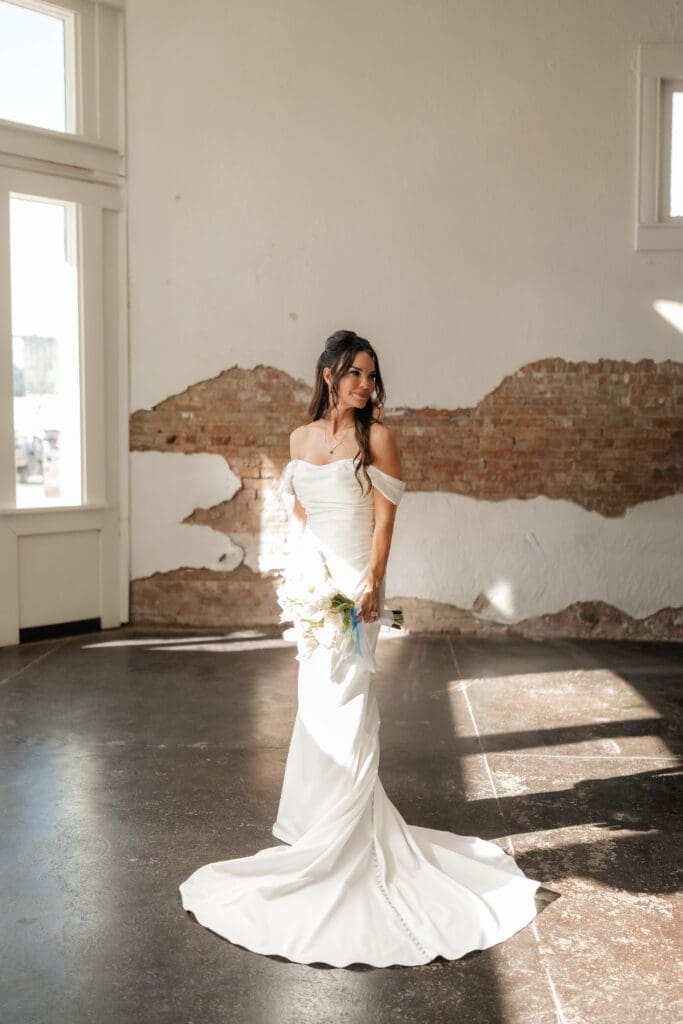 Bride posing for photos inside Soma Winery in Fort Worth, TX