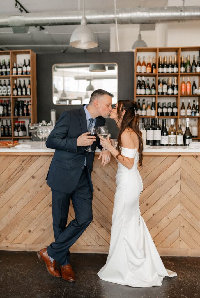 Bride and groom posing for photos inside Soma Winery in Fort Worth, TX