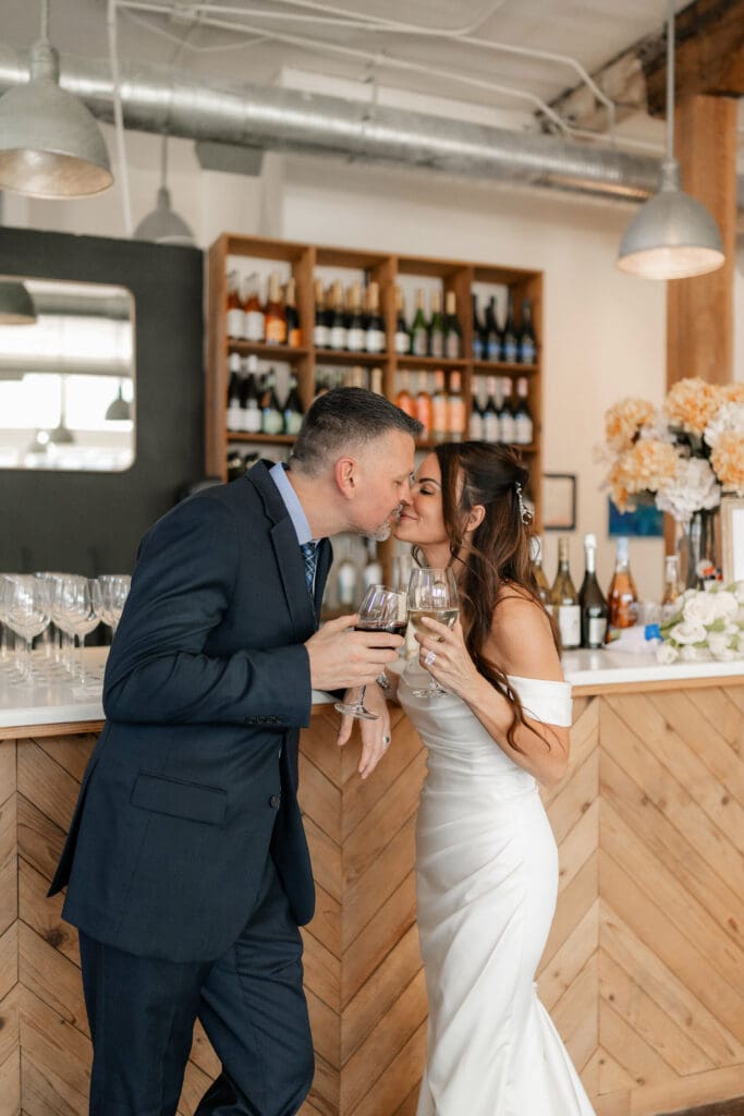 Bride and groom posing for photos inside Soma Winery in Fort Worth, TX