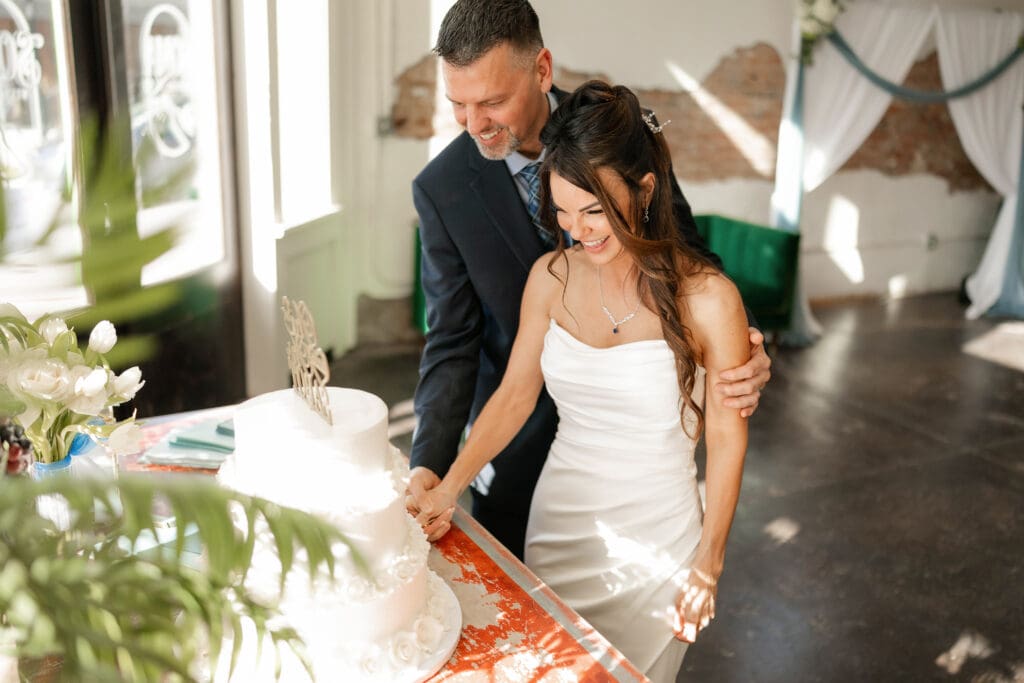 Bride and groom cutting their wedding cake at Soma Winery in Fort Worth, TX