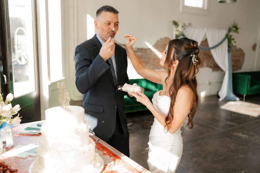 Bride and groom cutting their wedding cake at Soma Winery in Fort Worth, TX