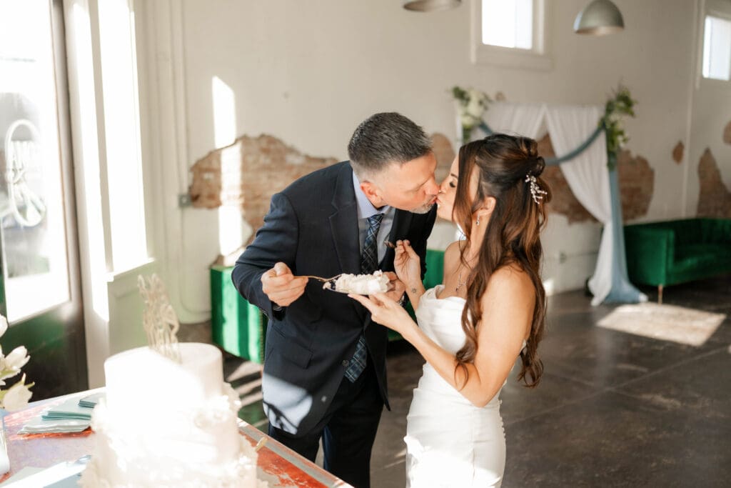 Bride and groom cutting their wedding cake at Soma Winery in Fort Worth, TX