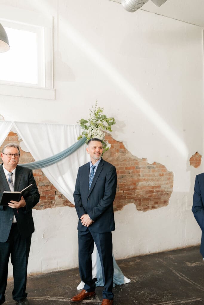 Groom waiting at the altar for his bride at Soma Winery in Fort Worth, TX