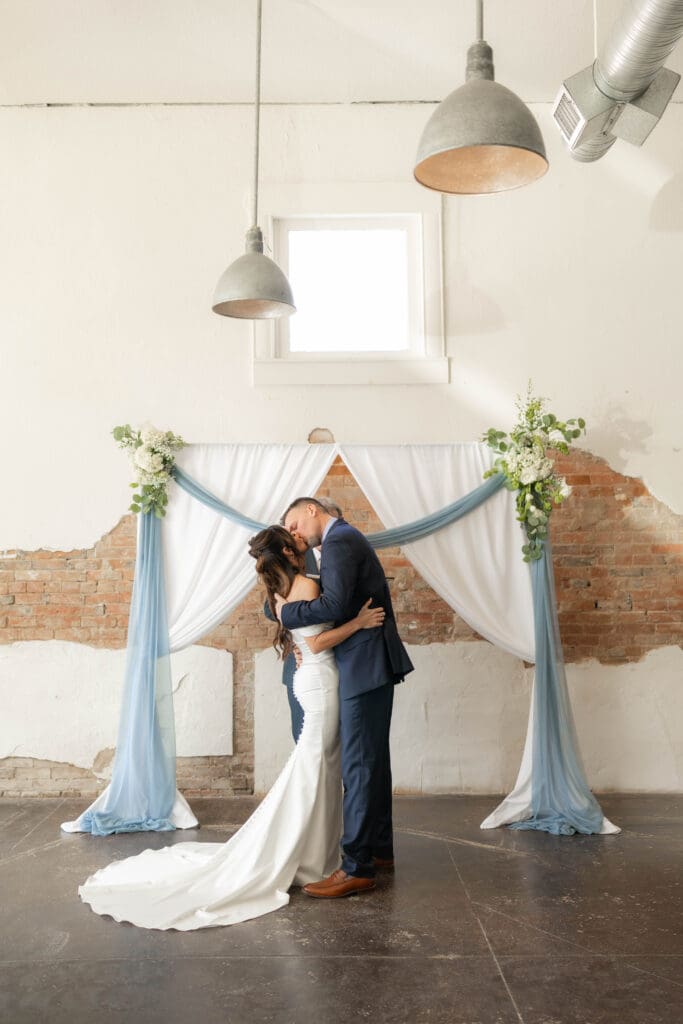 Bride and groom kissing at Soma Winery in Fort Worth, TX