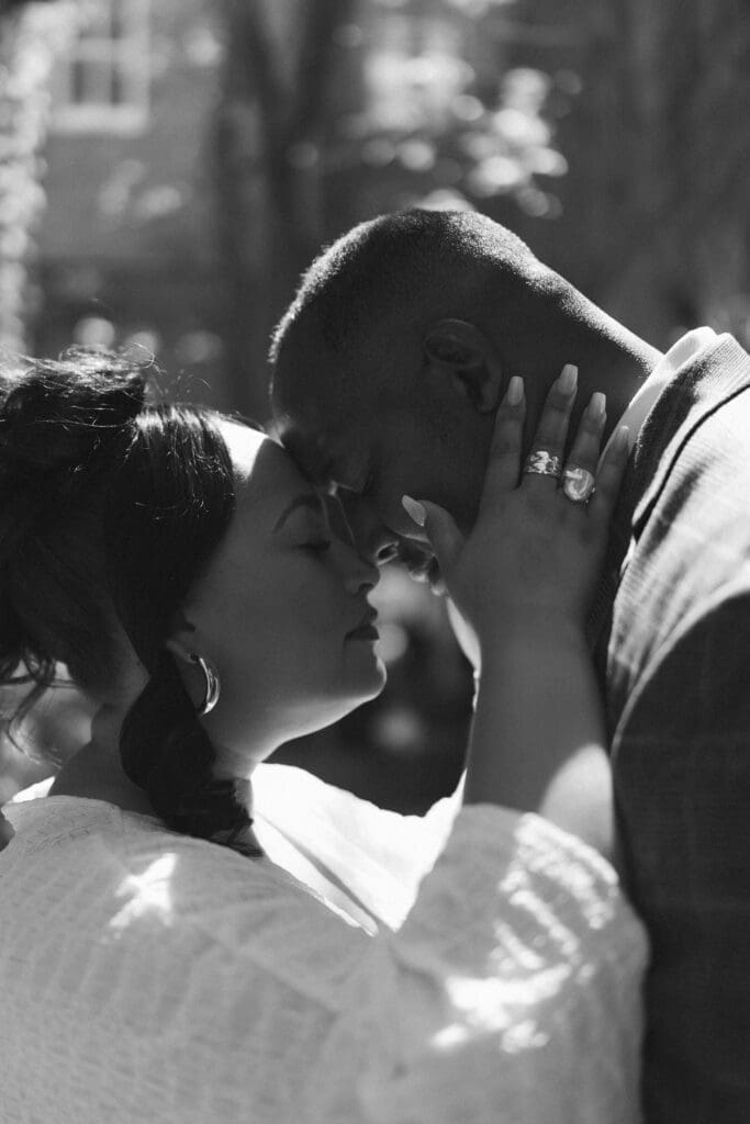 Moody portraits of a man and woman posing during their engagement session in downtown in Fort Worth, TX