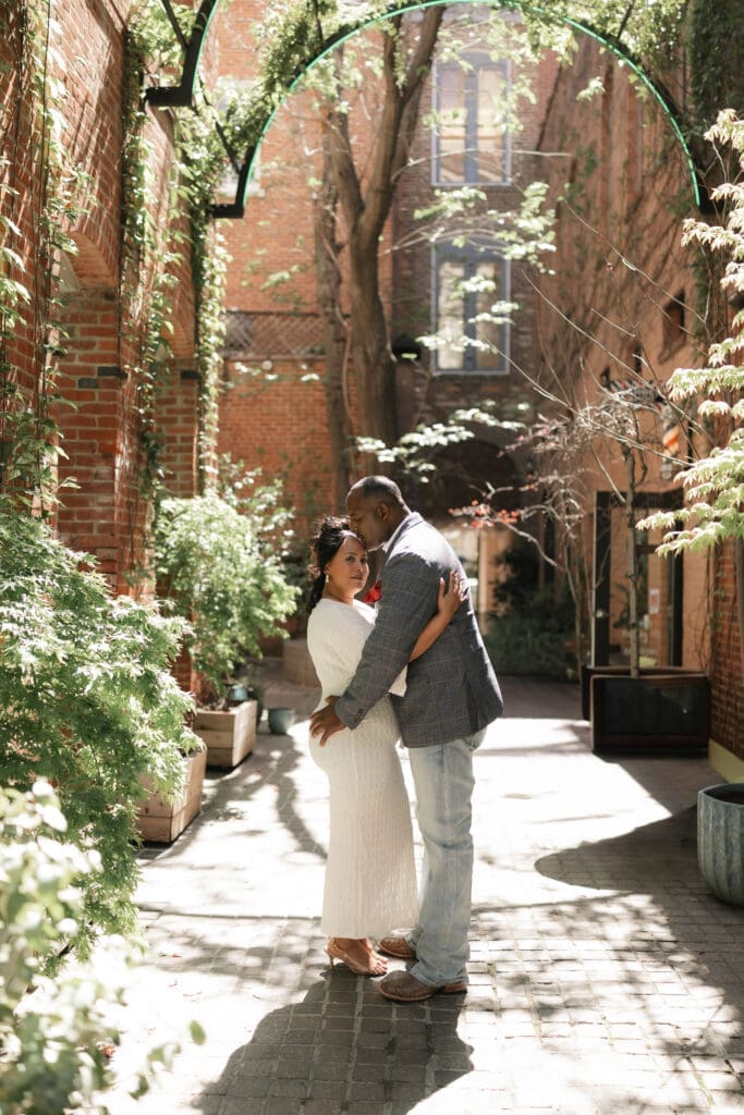Moody portraits of a man and woman posing during their engagement session in downtown in Fort Worth, TX