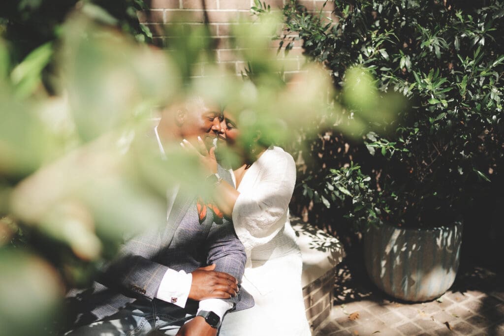 Moody portraits of a man and woman posing during their engagement session in downtown in Fort Worth, TX