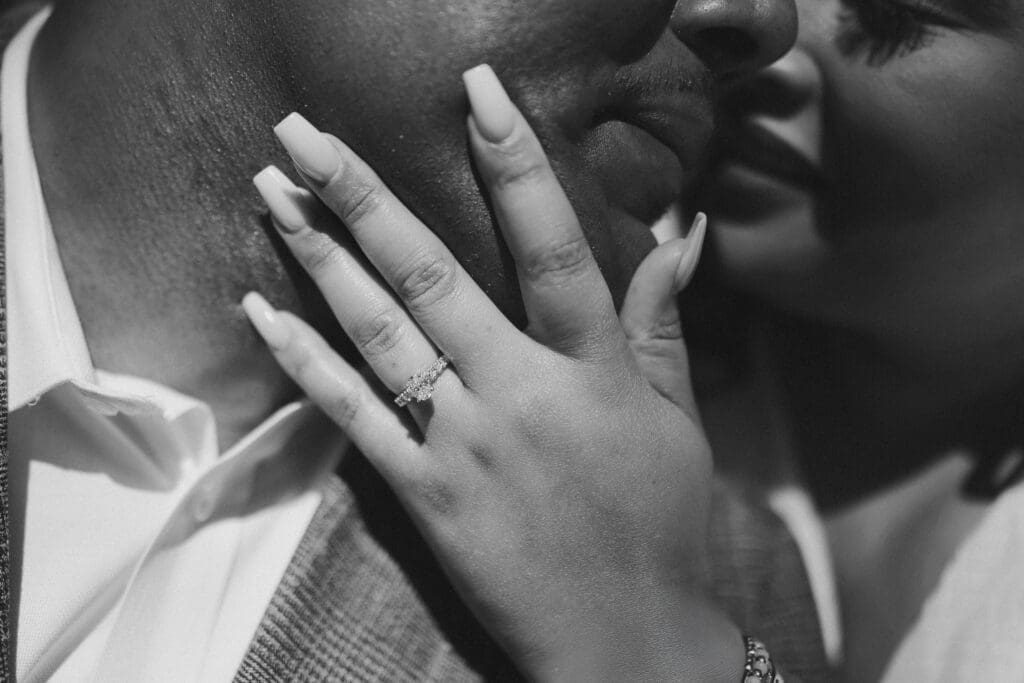 Black and white portraits of a man and woman posing during their engagement session in downtown in Fort Worth, TX