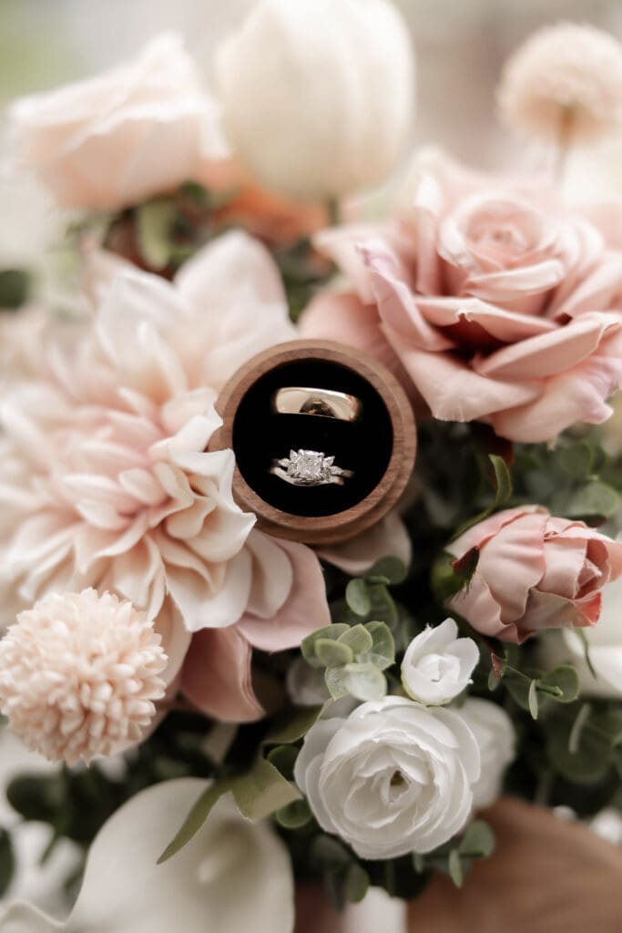 Closeup of bride and groom's rings in the bridal bouquet