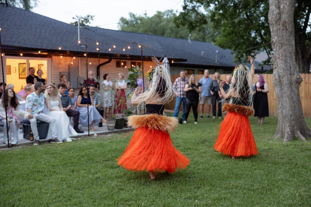 Bride and groom's rehearsal dinner in their backyard in Houston, TX with Polynesian hula dancers