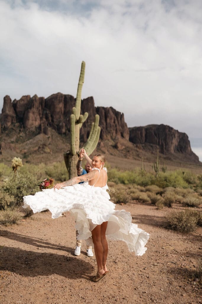 Portrait of bride and groom amongst the desert landscape during their Arizona destination wedding at Lost Dutchman State Park
