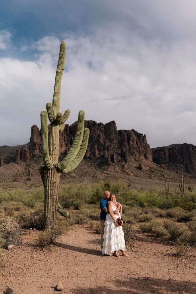 Portrait of bride and groom amongst the desert landscape during their Arizona destination wedding at Lost Dutchman State Park