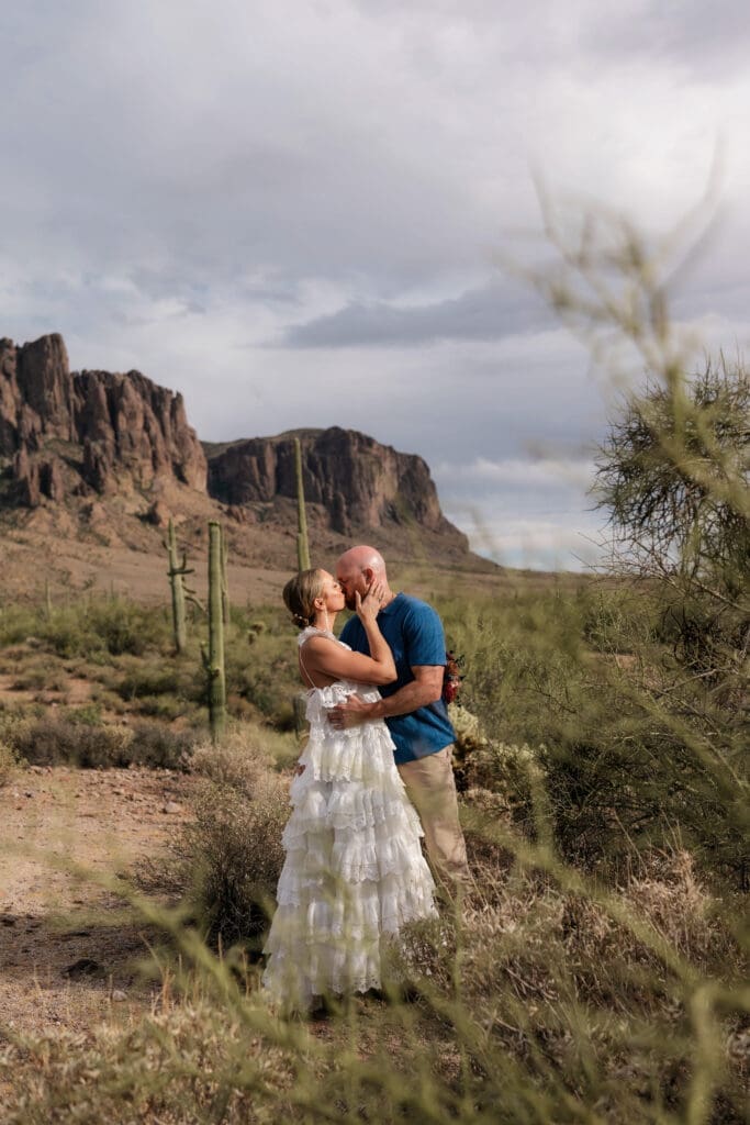 Portrait of bride and groom amongst the desert landscape during their Arizona destination wedding at Lost Dutchman State Park