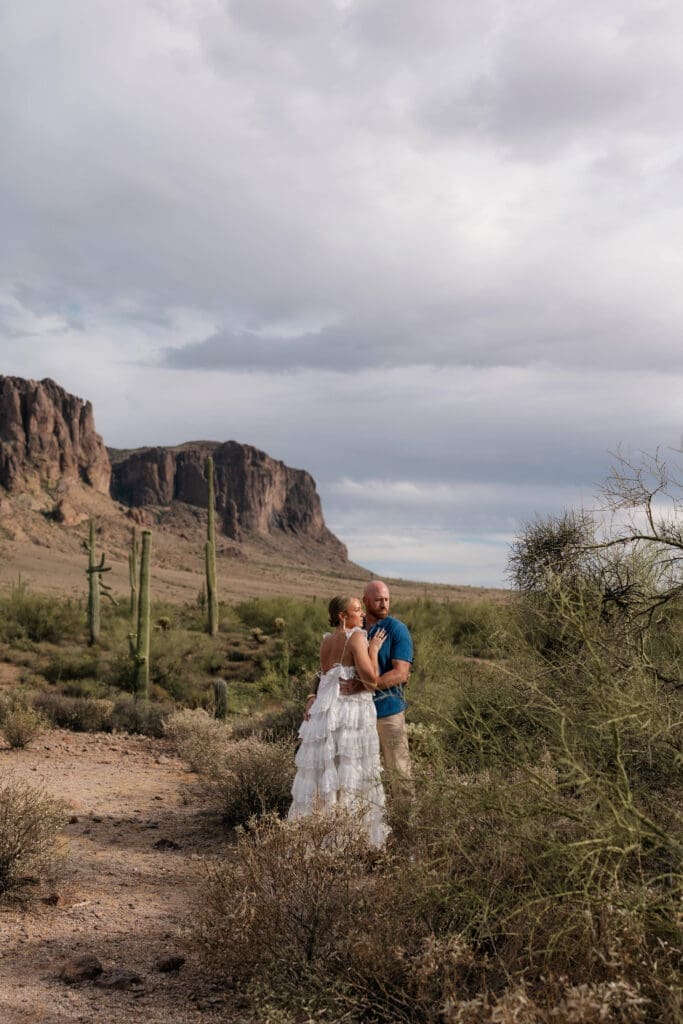 Portrait of bride and groom amongst the desert landscape during their Arizona destination wedding at Lost Dutchman State Park