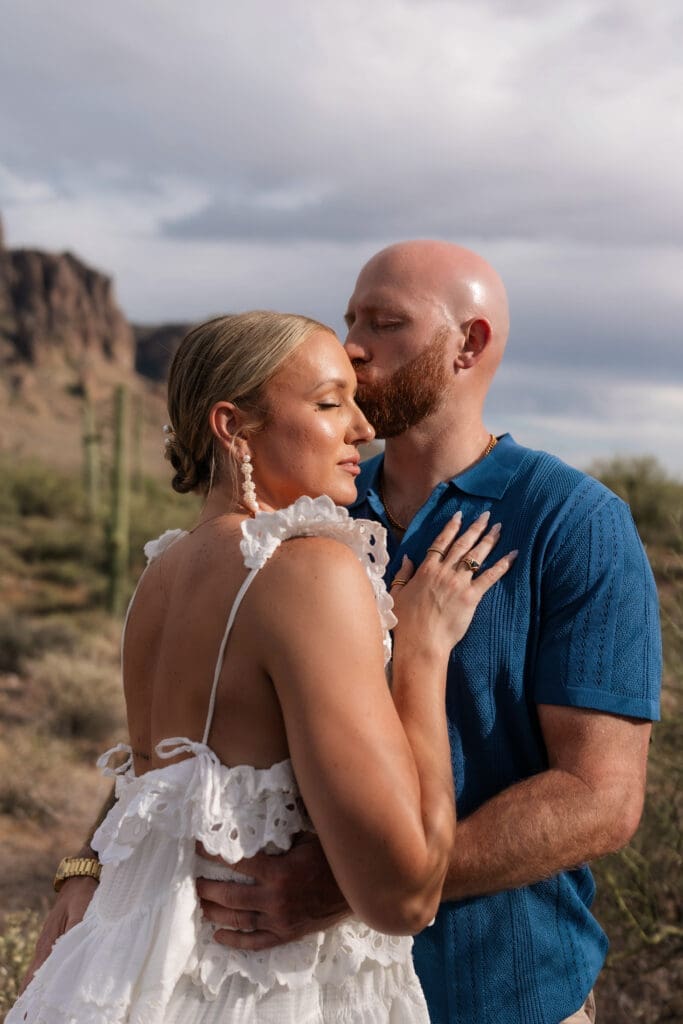Portrait of bride and groom amongst the desert landscape during their Arizona destination wedding at Lost Dutchman State Park