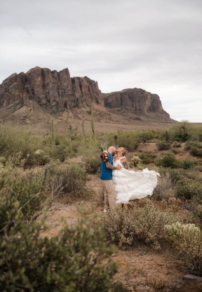 Portrait of bride and groom amongst the desert landscape during their Arizona destination wedding at Lost Dutchman State Park