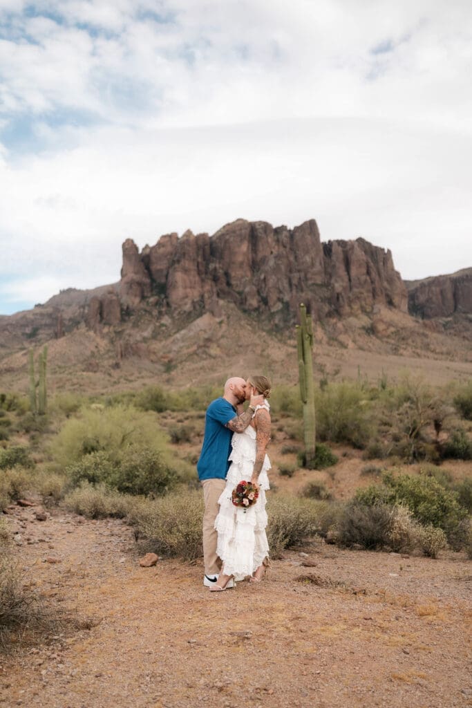 Portrait of bride and groom amongst the desert landscape during their Arizona destination wedding at Lost Dutchman State Park