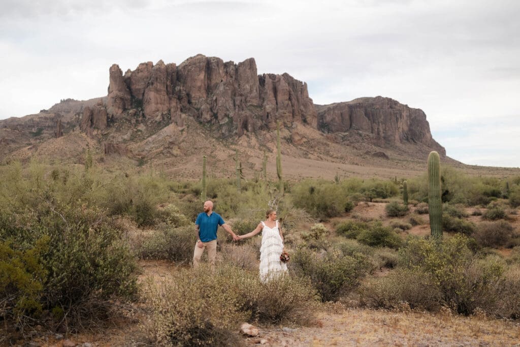 Portrait of bride and groom amongst the desert landscape during their Arizona destination wedding at Lost Dutchman State Park