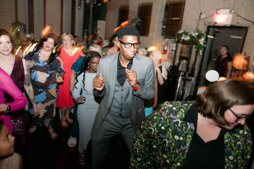 Wedding guests partying and dancing it up on the dancefloor at Nouveau Antique Art Bar in Houston, TX