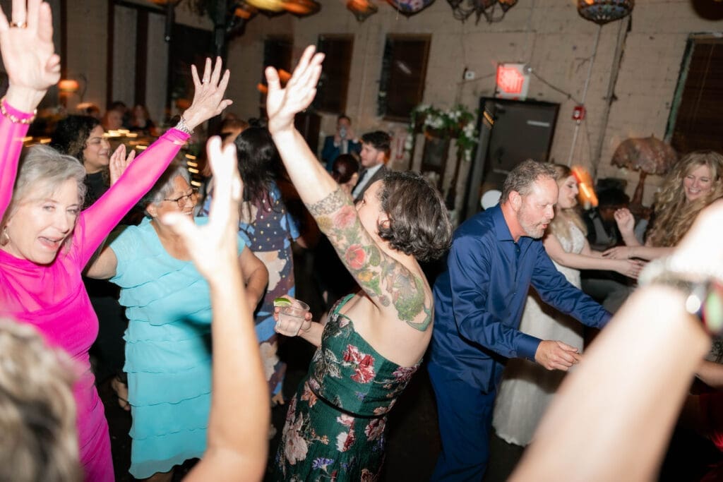 Wedding guests partying and dancing it up on the dancefloor at Nouveau Antique Art Bar in Houston, TX
