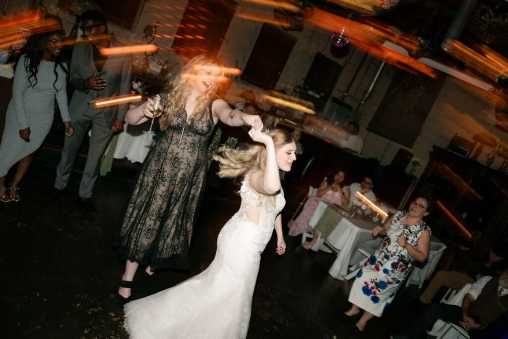 Wedding guests partying and dancing it up on the dancefloor at Nouveau Antique Art Bar in Houston, TX
