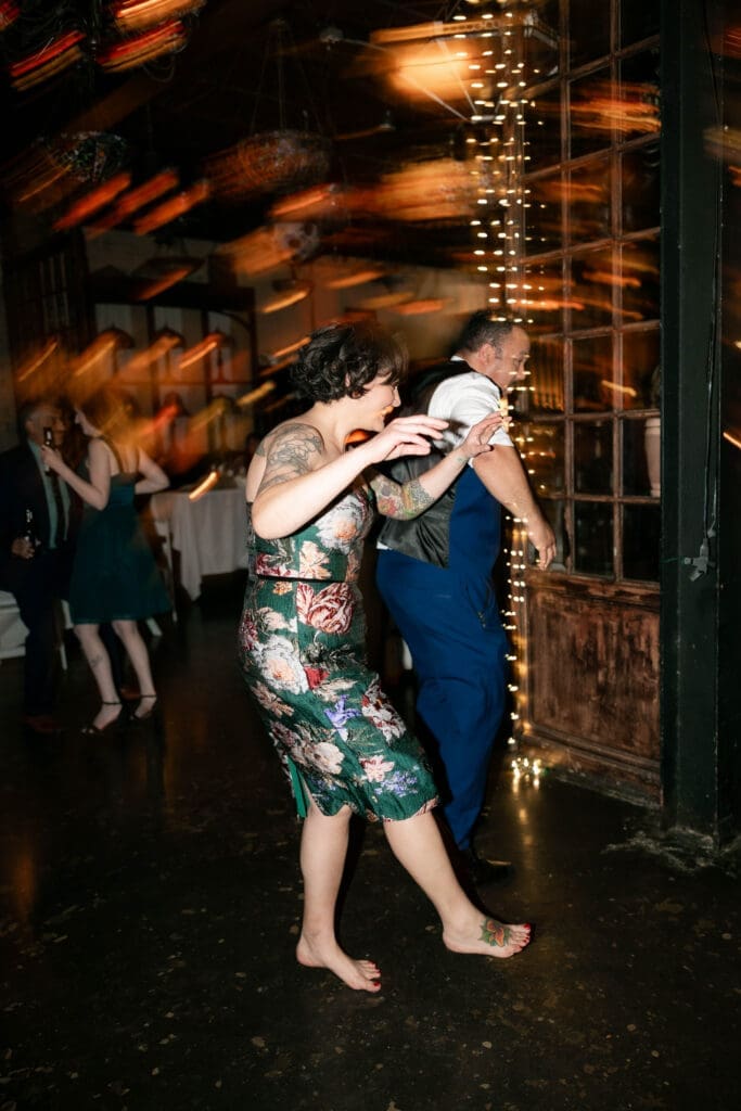 Wedding guests partying and dancing it up on the dancefloor at Nouveau Antique Art Bar in Houston, TX