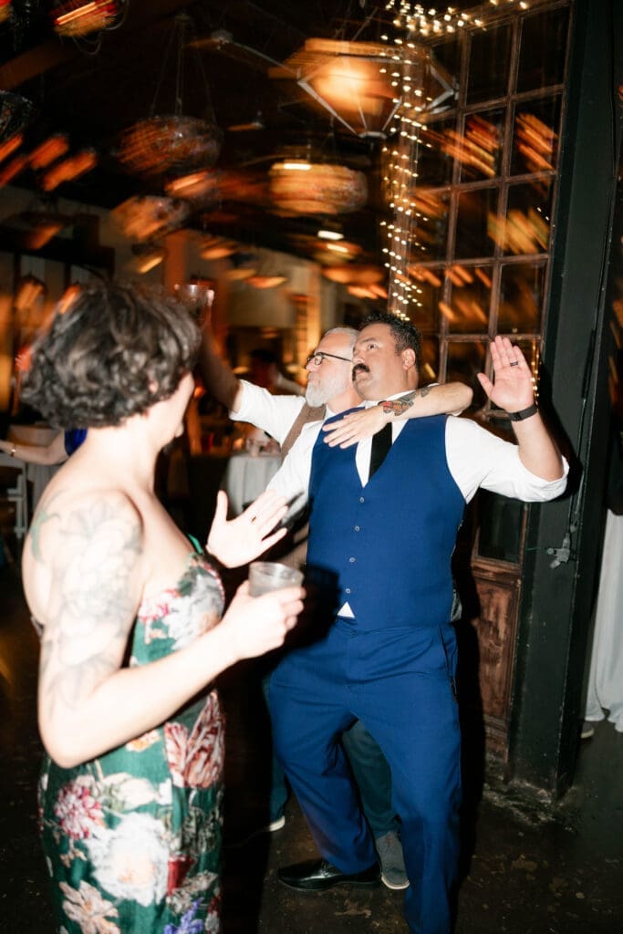 Wedding guests partying and dancing it up on the dancefloor at Nouveau Antique Art Bar in Houston, TX