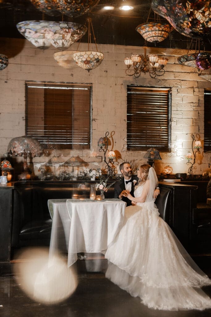 Bride and groom's moody indoor portraits at their Nouveau Antique Bar wedding in Houston, TX